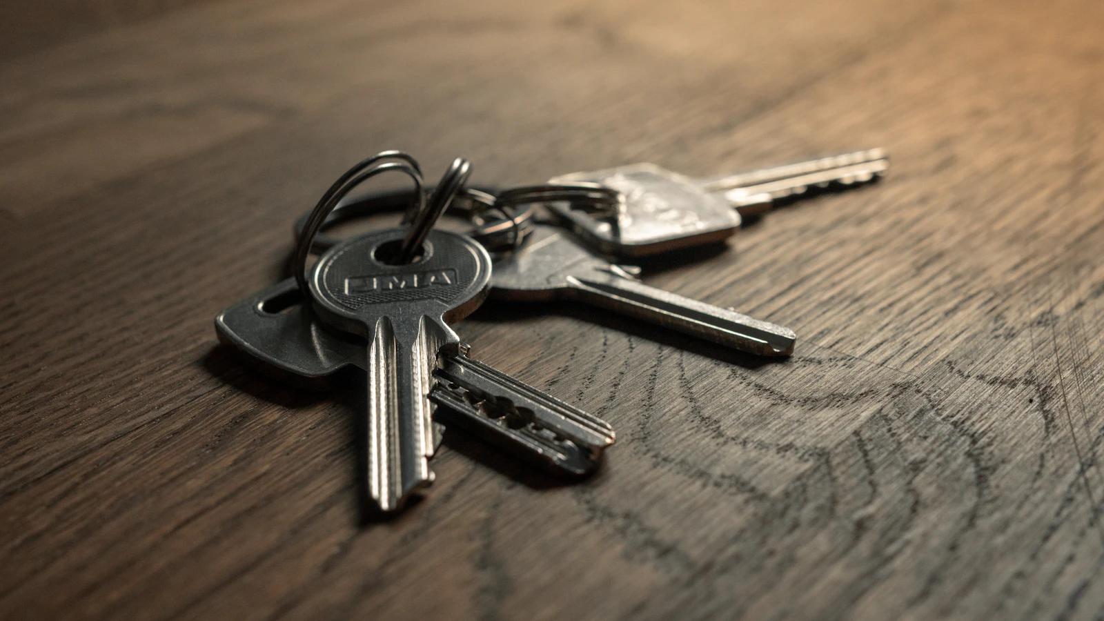 A bunch of keys sitting on a wooden table